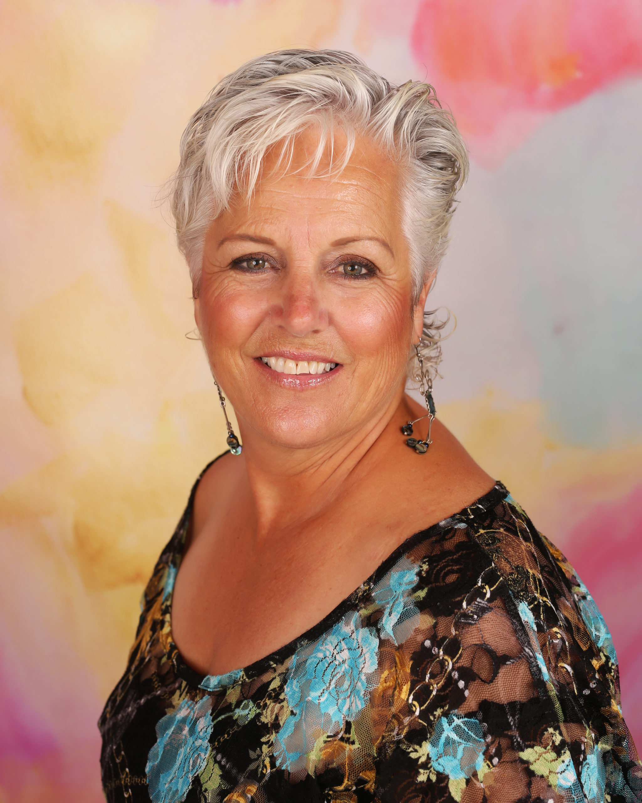 A woman with white hair and wearing a black dress.