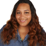 A woman with long hair is smiling for the camera.