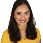 A woman in yellow shirt smiling for the camera.